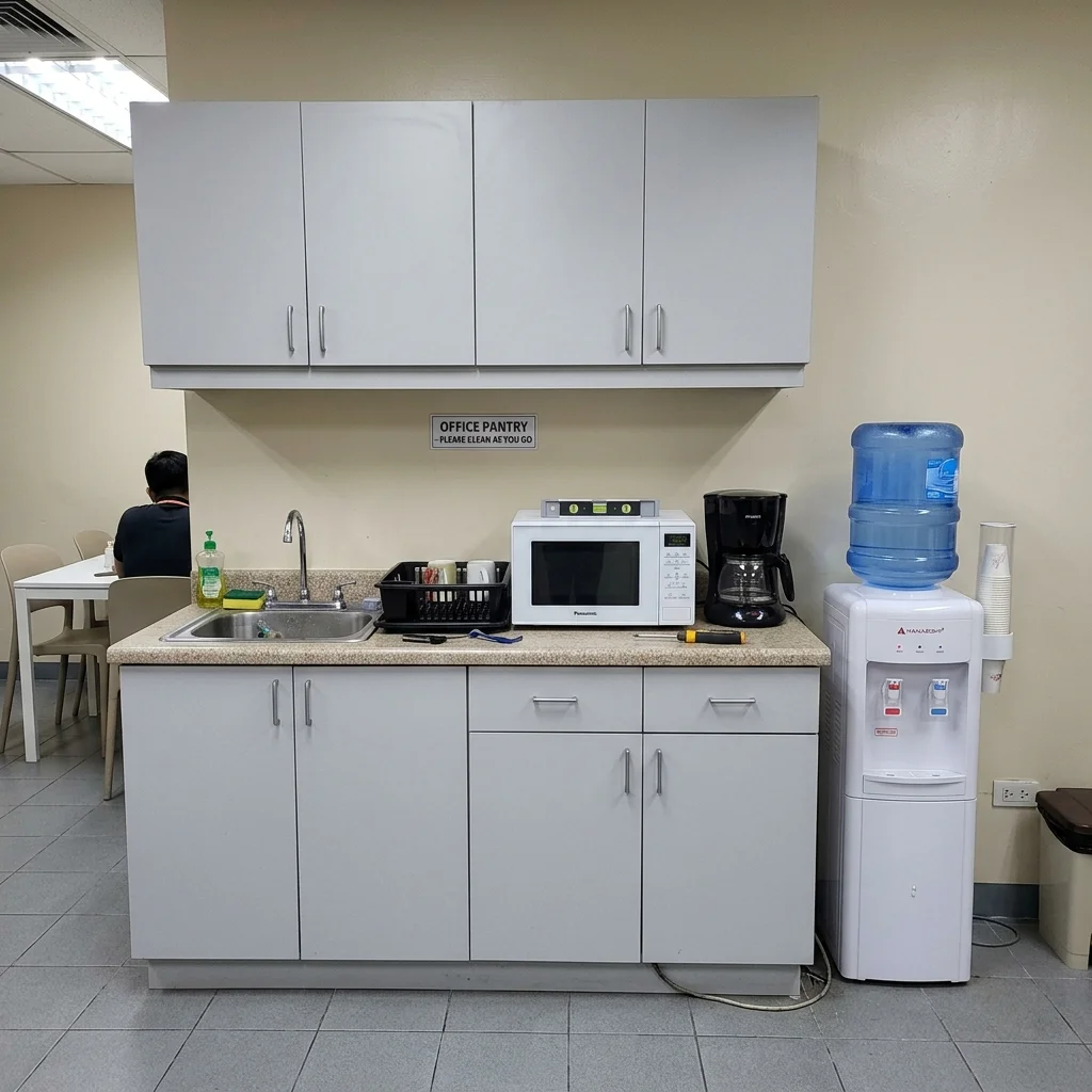 Custom office pantry cabinets with gray laminate finish installed in a Philippine corporate break room